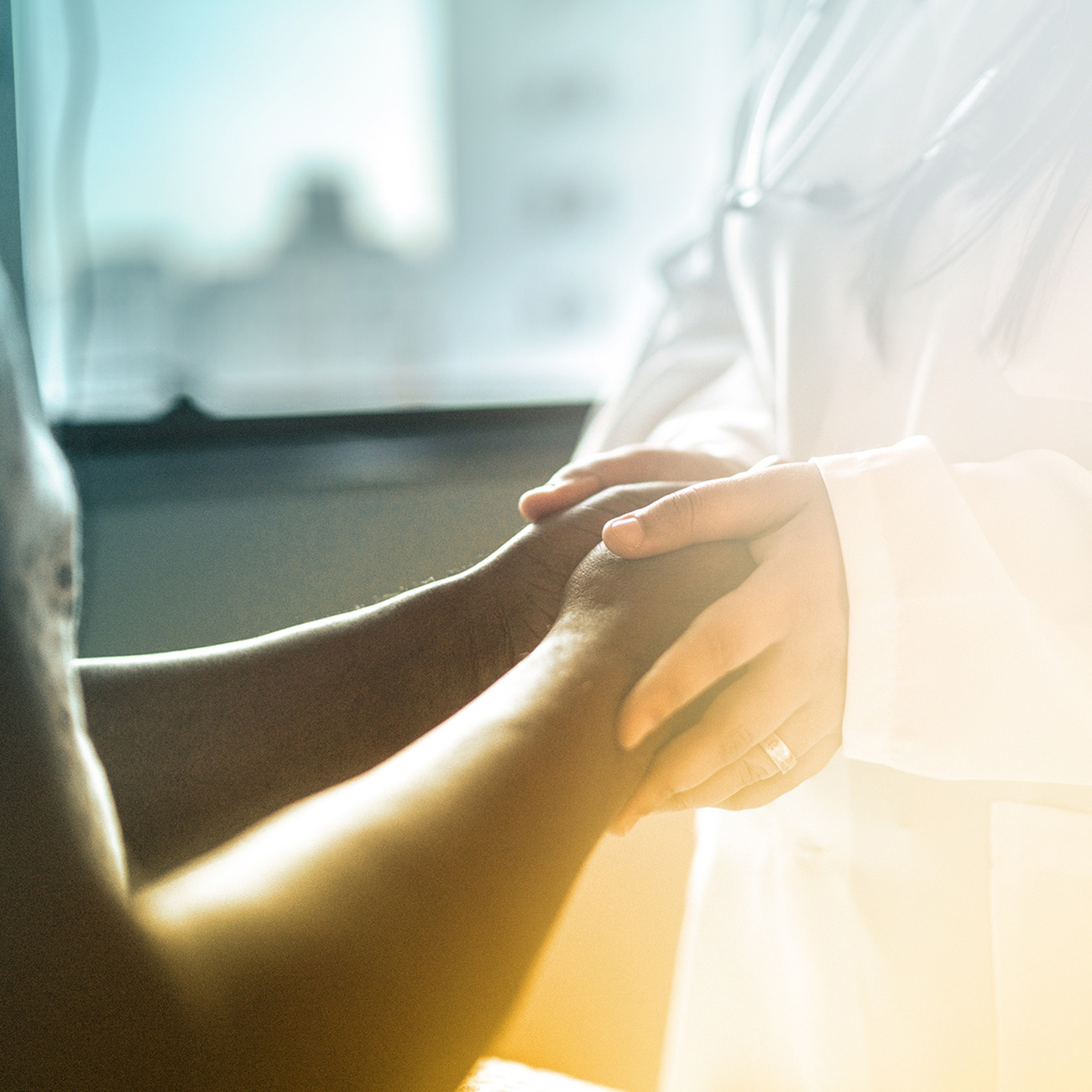 Doctor holding patient's hands