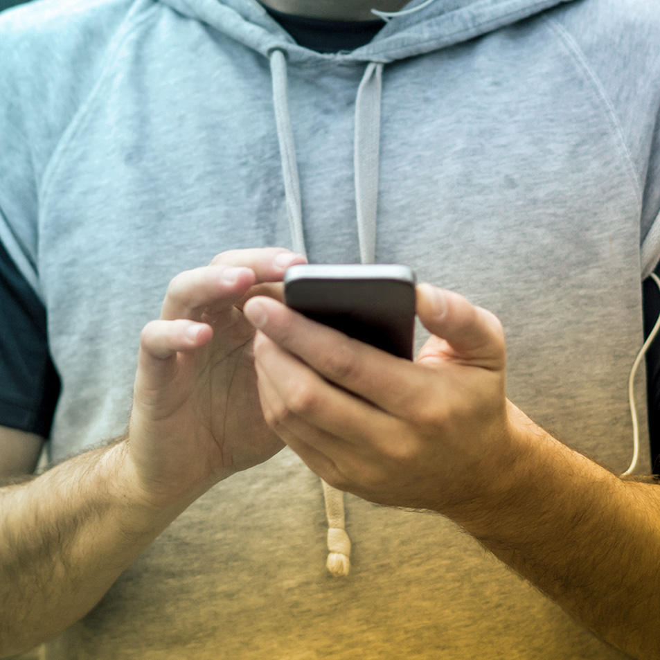 Man's hands holding his phone